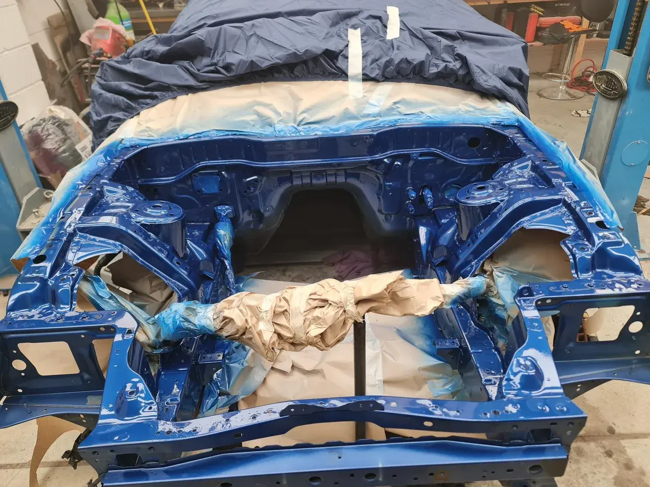 Car engine bay resprayed in blue during restoration work
