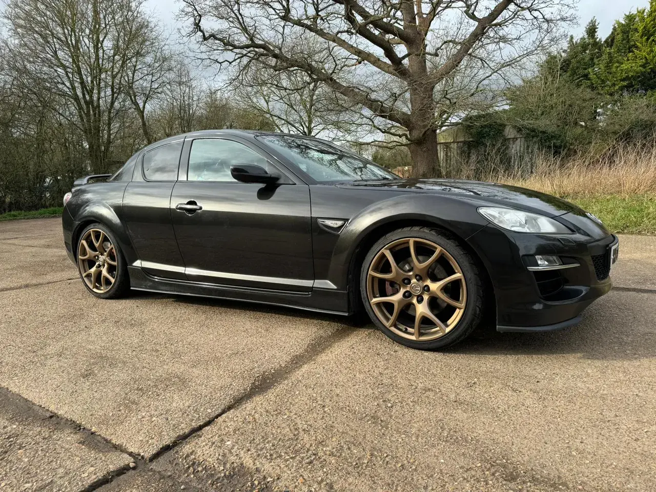 Black Mazda RX-8 with bronze alloy wheels