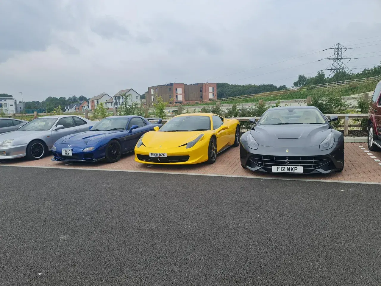 Ferrari and supercar line-up outside the workshop